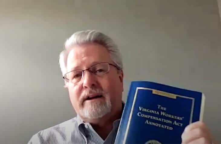 Robert Guntharp showing the Virginia Workers's Comp book